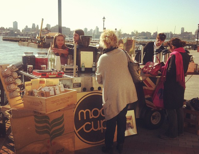 Original modcup coffee cart serving in Hoboken in front of NYC skyline